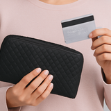 women taking a credit card out of a black wallet | Prolong Lash