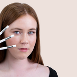 women holding three lash cleansing brushes up to her face | Prolong Lash