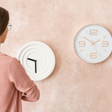 Women with back to camera looking at a range of different clocks