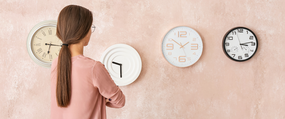Women with back to camera looking at a range of different clocks